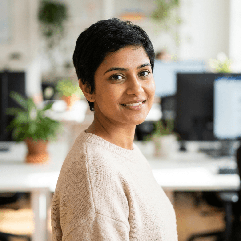 Woman in her mid 20s, South Asian, clean brows, natural makeup, friendly expression, professional headshot