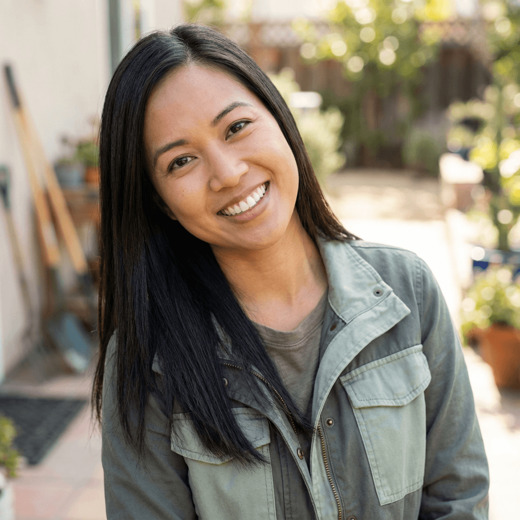 Amelia Chen smiling softly in a bright modern salon